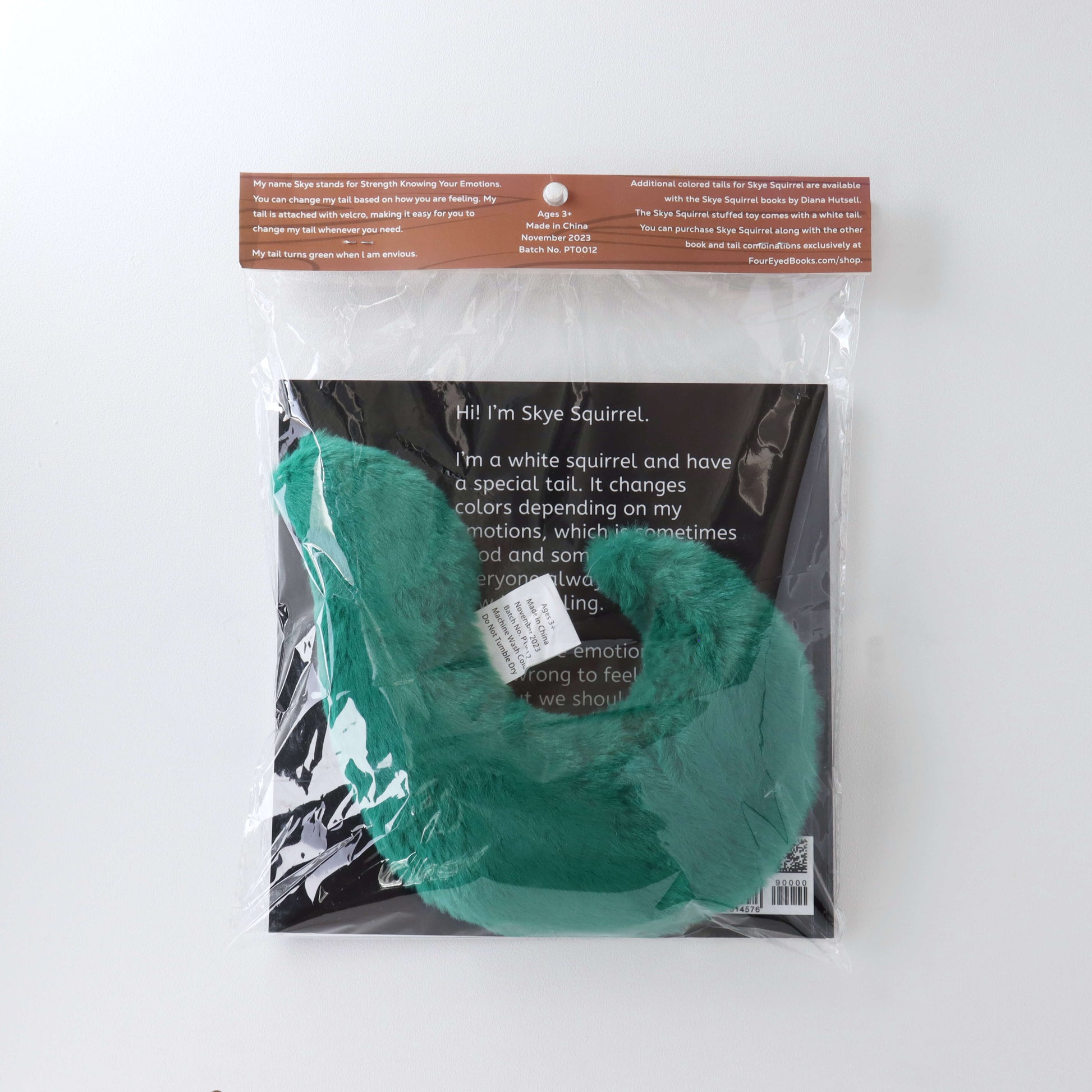 Green Stuffed Tail in plastic packaging with book (back)