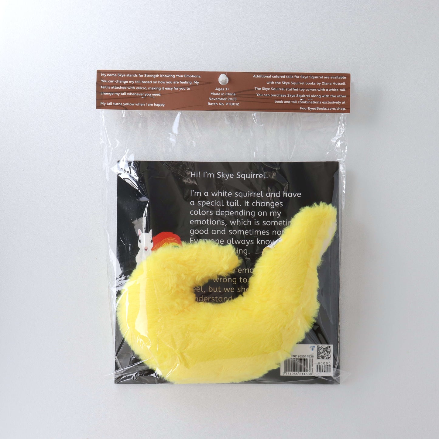 Yellow Stuffed Tail in plastic packaging with book (back)