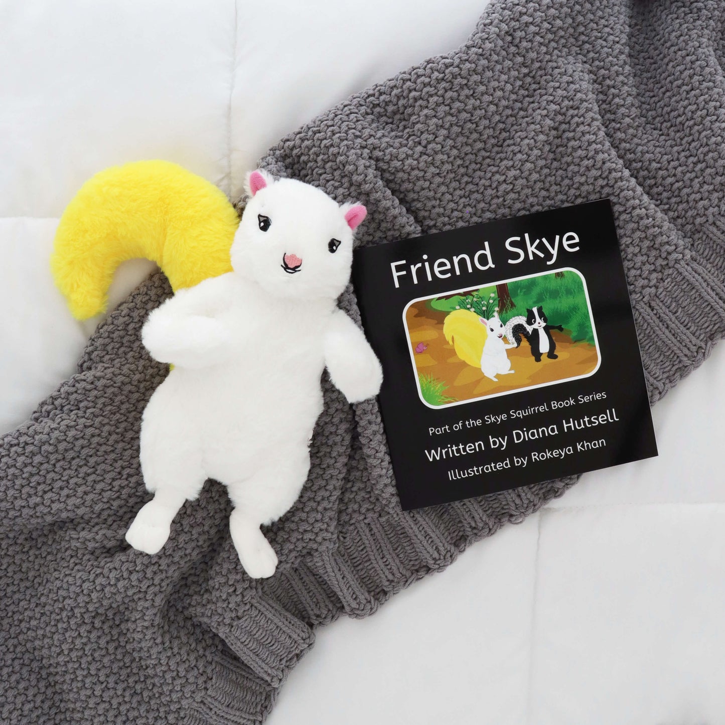 Friend Skye Book with Skye Squirrel with Yellow Stuffed Tail on a gray blanket