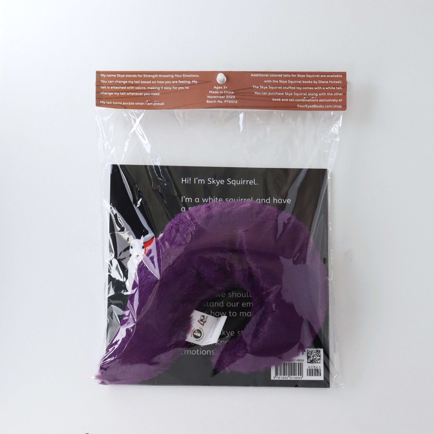 Purple Stuffed Tail in plastic packaging with book (back)