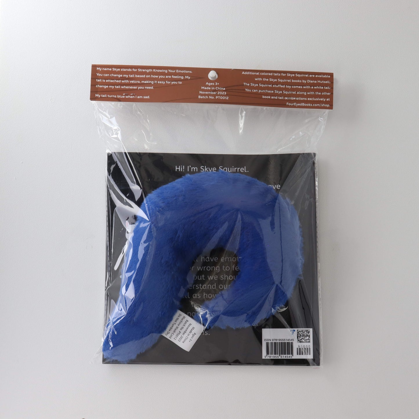 Blue Stuffed Tail in plastic packaging with book (back)