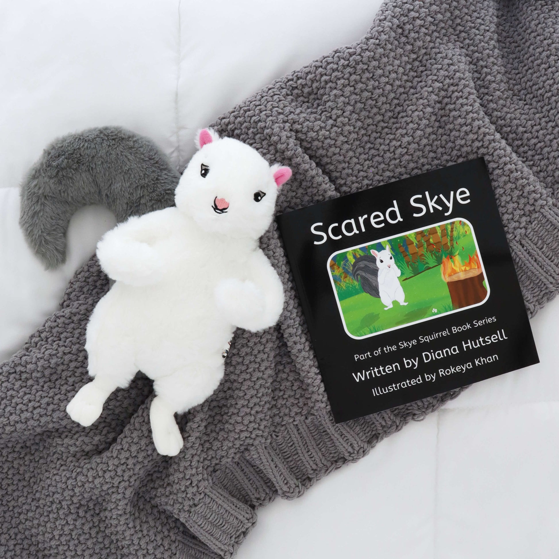 Scared Skye Book with Skye Squirrel with Gray Stuffed Tail on a gray blanket